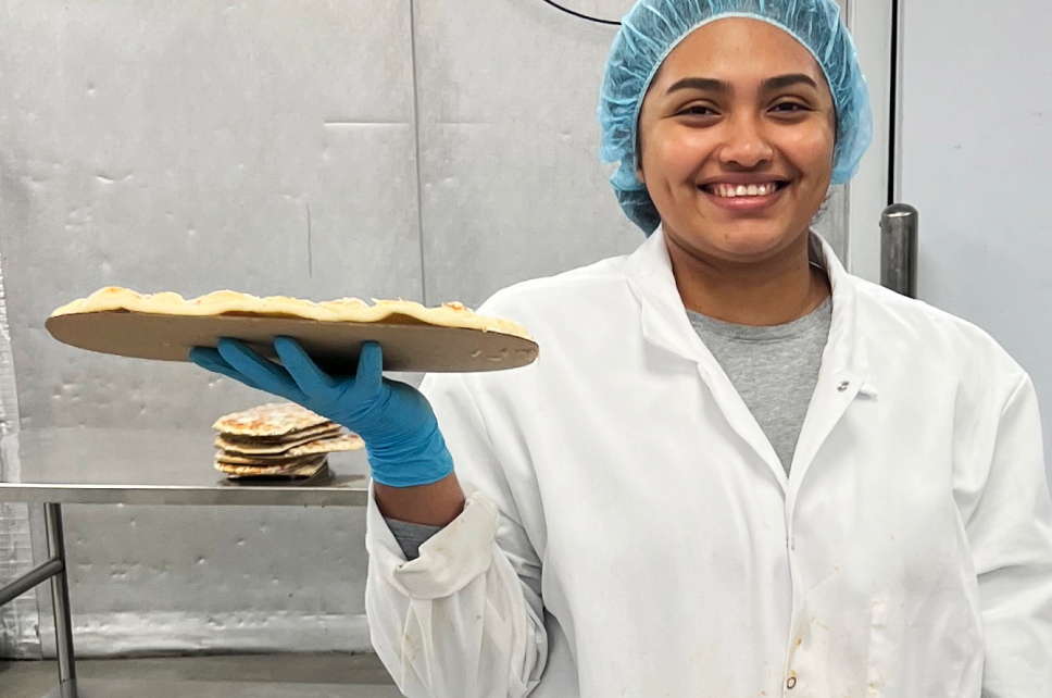 woman holding up pizza crust